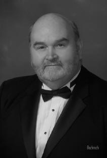 Photograph of Director Richard Travers in a tuxedo